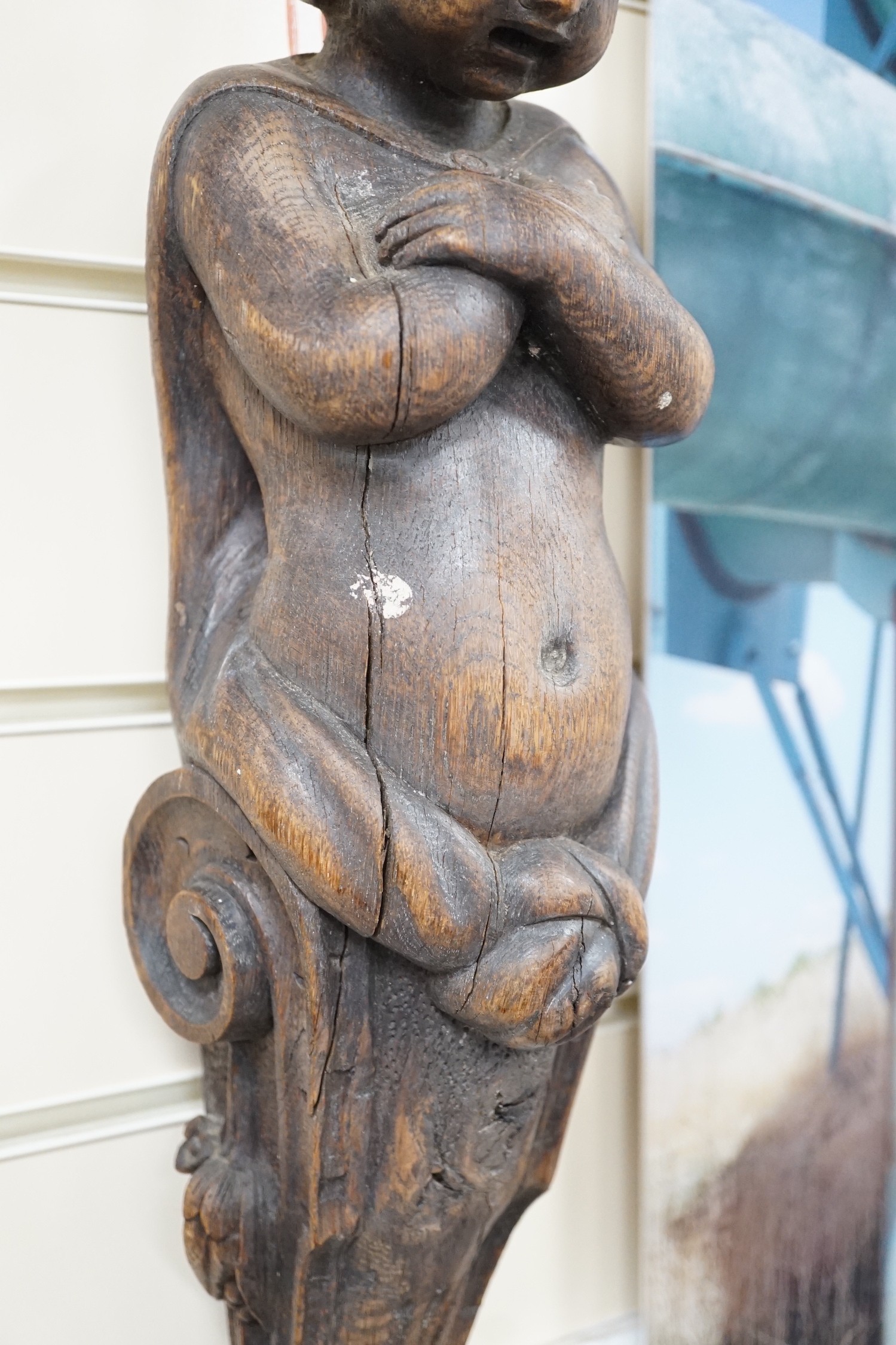 A carved figural wall mount. 64cm tall
